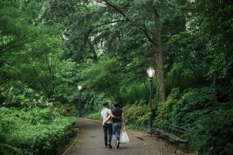 a man and a woman walking down a path in a park, inspired by Nan Goldin, unsplash, lush brooklyn urban landscaping, vendors, ignant, delightful surroundings