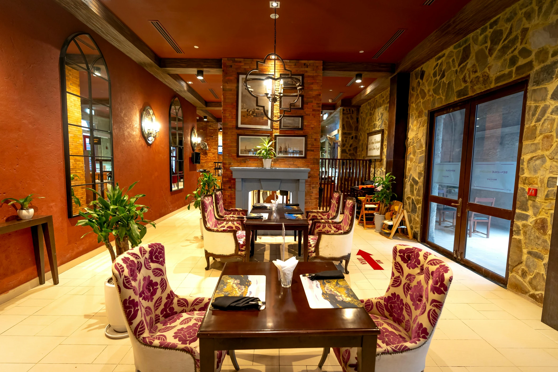 tables and chairs in a room filled with windows