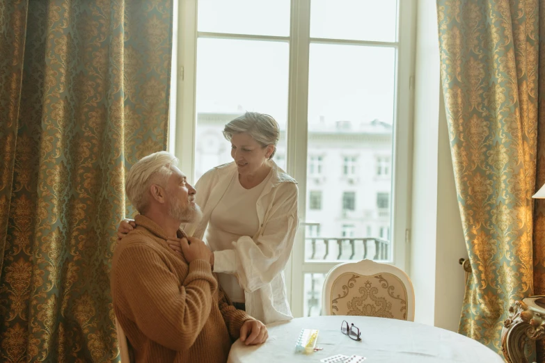 the man and woman are having conversation at the table