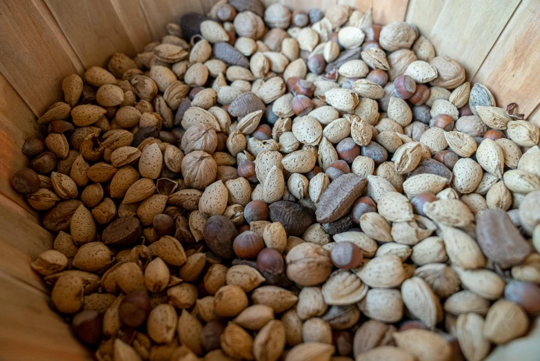 a wooden bowl filled with nuts sitting on top of a table, thumbnail, market, new mexico, high quality product image”