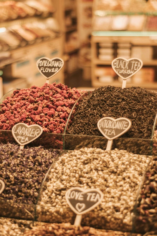 a store filled with lots of different types of nuts, trending on pexels, renaissance, herbs and flowers, hearts, black, “berries