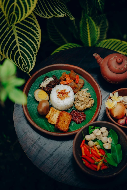 a table topped with bowls filled with different types of food, sumatraism, medium detail, greenery, square, 6 k