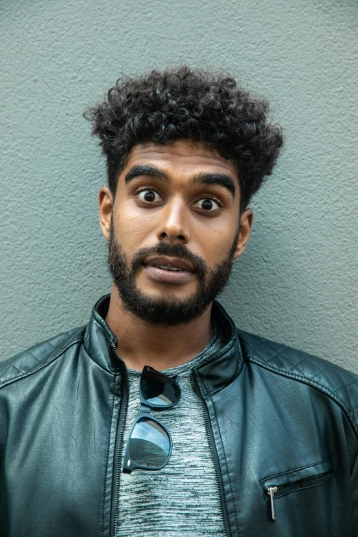 a close up of a person wearing a leather jacket, trending on pexels, renaissance, expressive surprised expression, vinayak, curls on top of his head, non-binary