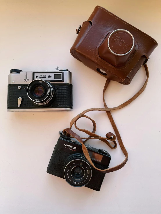 a leather camera and a brown leather bag