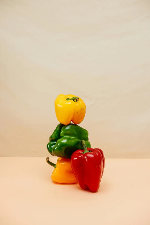 a couple of peppers sitting next to each other, a surrealist sculpture, inspired by Fernando Botero, multicolored