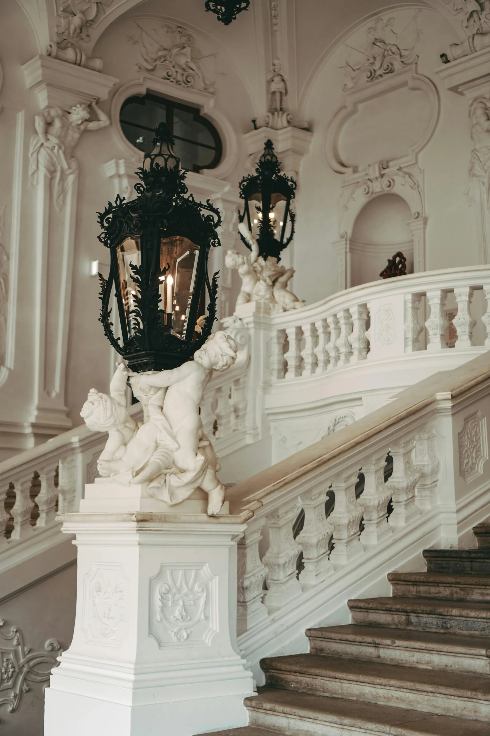 a couple of lamps sitting on top of a set of stairs, a marble sculpture, inspired by Mihály Munkácsy, baroque, museum, balconies, intricate detailing, looking downwards