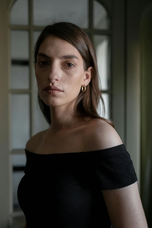 a woman in a black off the shoulder top, inspired by Elsa Bleda, renaissance, looking straight into camera, nonbinary model, thin aged 2 5, demna gvasalia