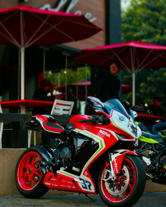 a red and green motorcycle parked in front of a restaurant, by Carlo Martini, pexels contest winner, honda rc 2 1 3, replica model, veneno, 2 5 6 x 2 5 6 pixels