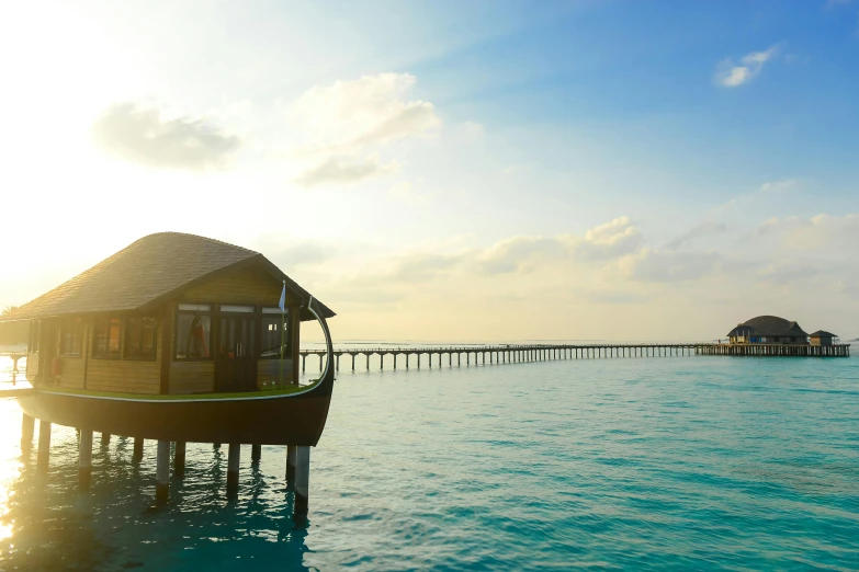 a house sits in the water with a pier on it