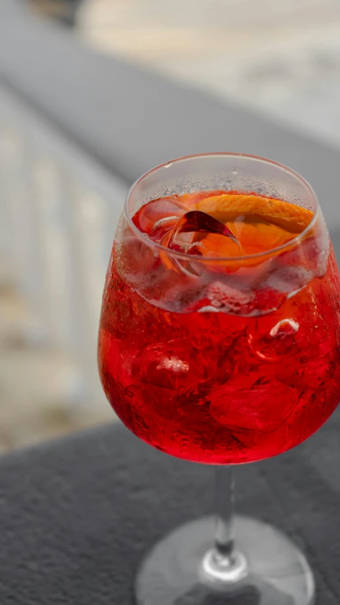 a close up of a wine glass on a table, large cornicione, soda, marbella, thumbnail