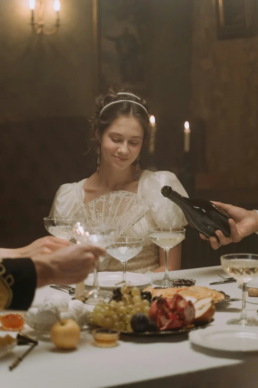 the bride and groom are sitting at the table having a meal