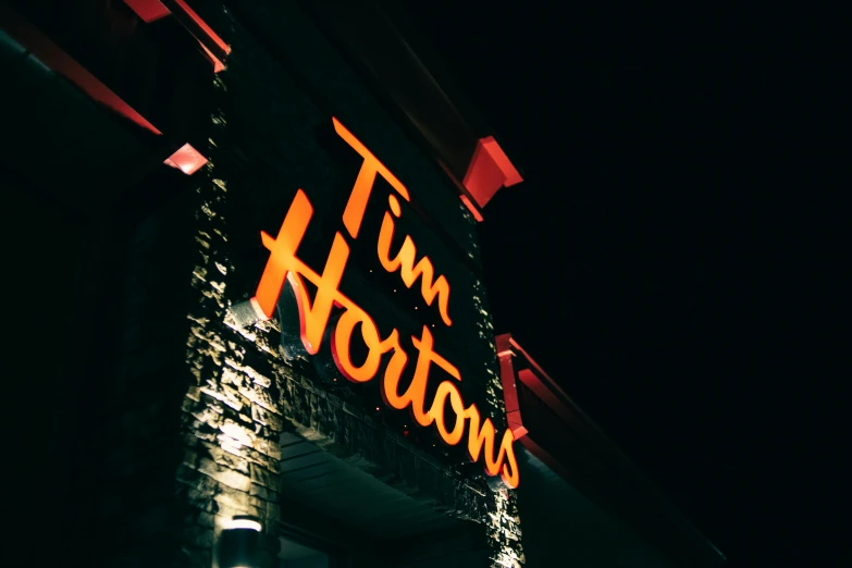 the front of a restaurant lit up at night, an album cover, by Tom Palin, trending on unsplash, golden arches, tom hiddleston, thumbnail, tim booth