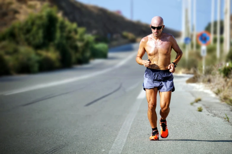 an older man wearing sunglasses while jogging