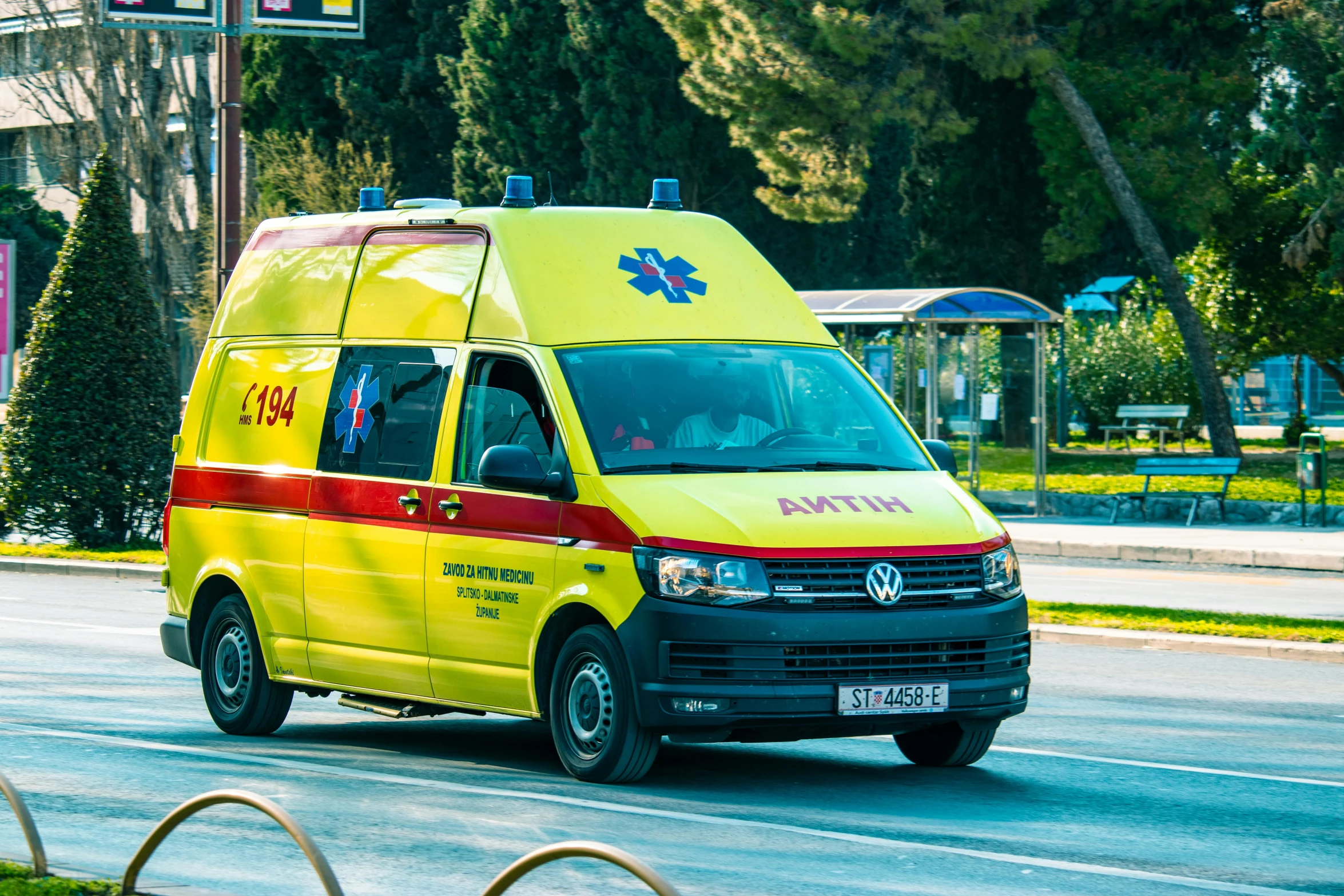 a yellow ambulance is driving down the street, by Adam Marczyński, shutterstock, hurufiyya, square, greek, avatar image, shot on sony a 7