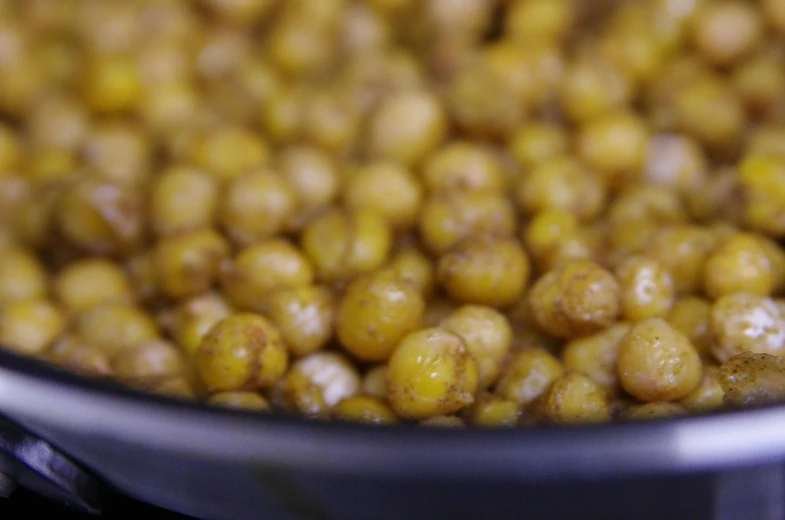 a pan filled with cooked chickpeas on top of a stove, by Carey Morris, closeup 4k, fan favorite, ground - level medium shot, portrait closeup