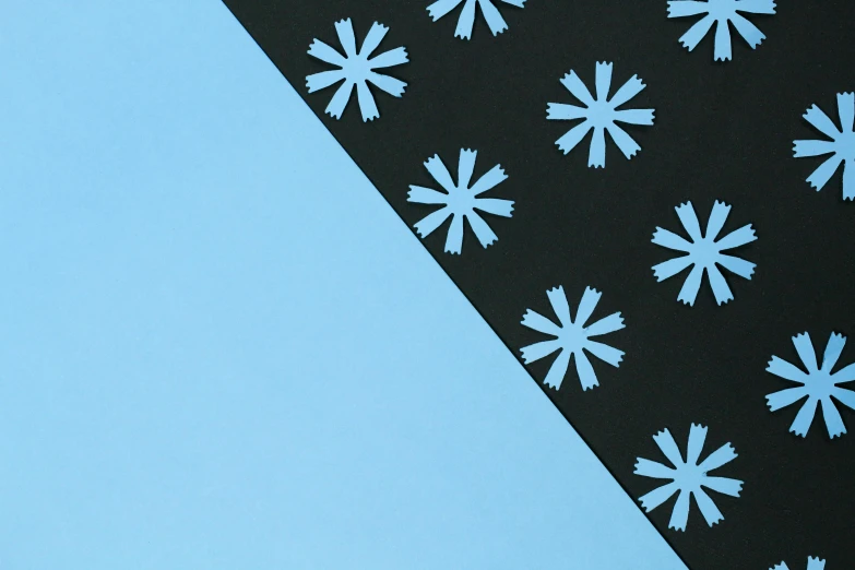 a black and white paper with snowflakes on it, inspired by George Ault, unsplash, minimalism, dayglo blue, diagonal, flower power, material design