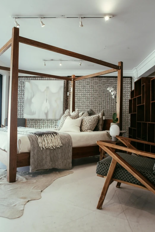 a bed and desk in a bedroom with an art piece on the wall