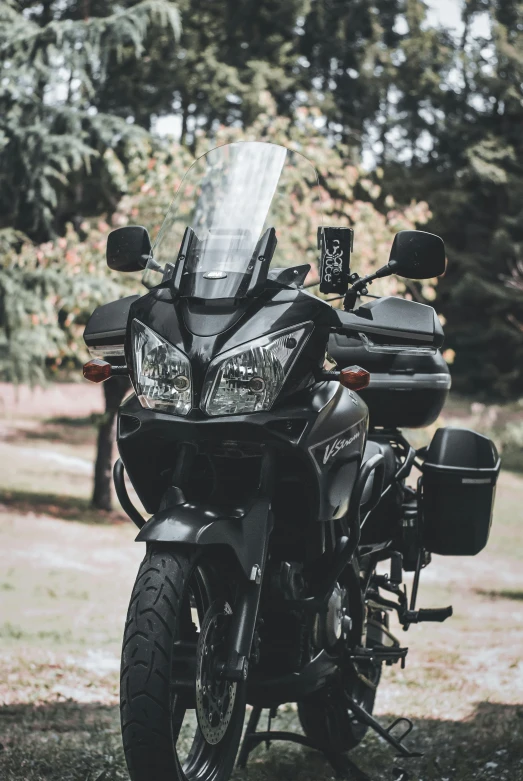 a black motorcycle parked on a dirt road, pexels contest winner, samurai jetstream sam, transparent black windshield, avatar image, islamic