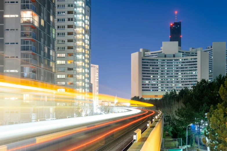 a train traveling through a city next to tall buildings, espoo, technological lights, in tokio, instagram post