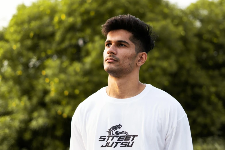 a man in a white shirt holding a frisbee, a portrait, inspired by Saurabh Jethani, pexels contest winner, graffiti, strong jawline, profile image, wearing a tee shirt and combats, quiet street