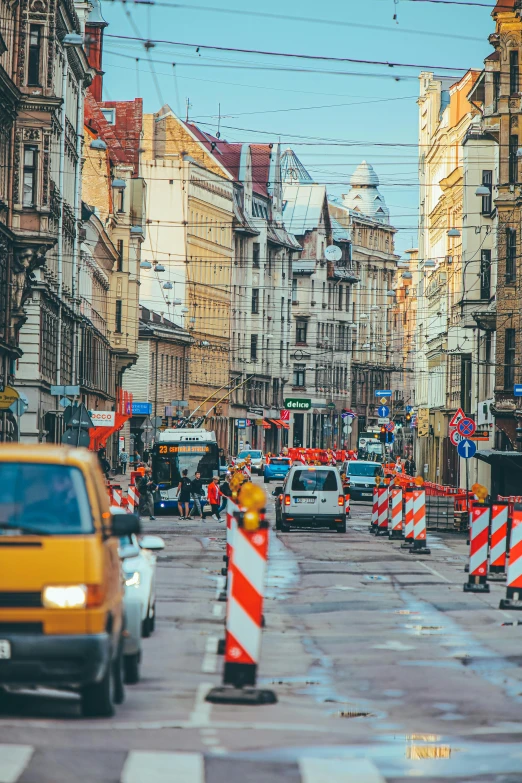 a street filled with lots of traffic next to tall buildings, viennese actionism, under repairs, lviv historic centre, instagram picture, construction site