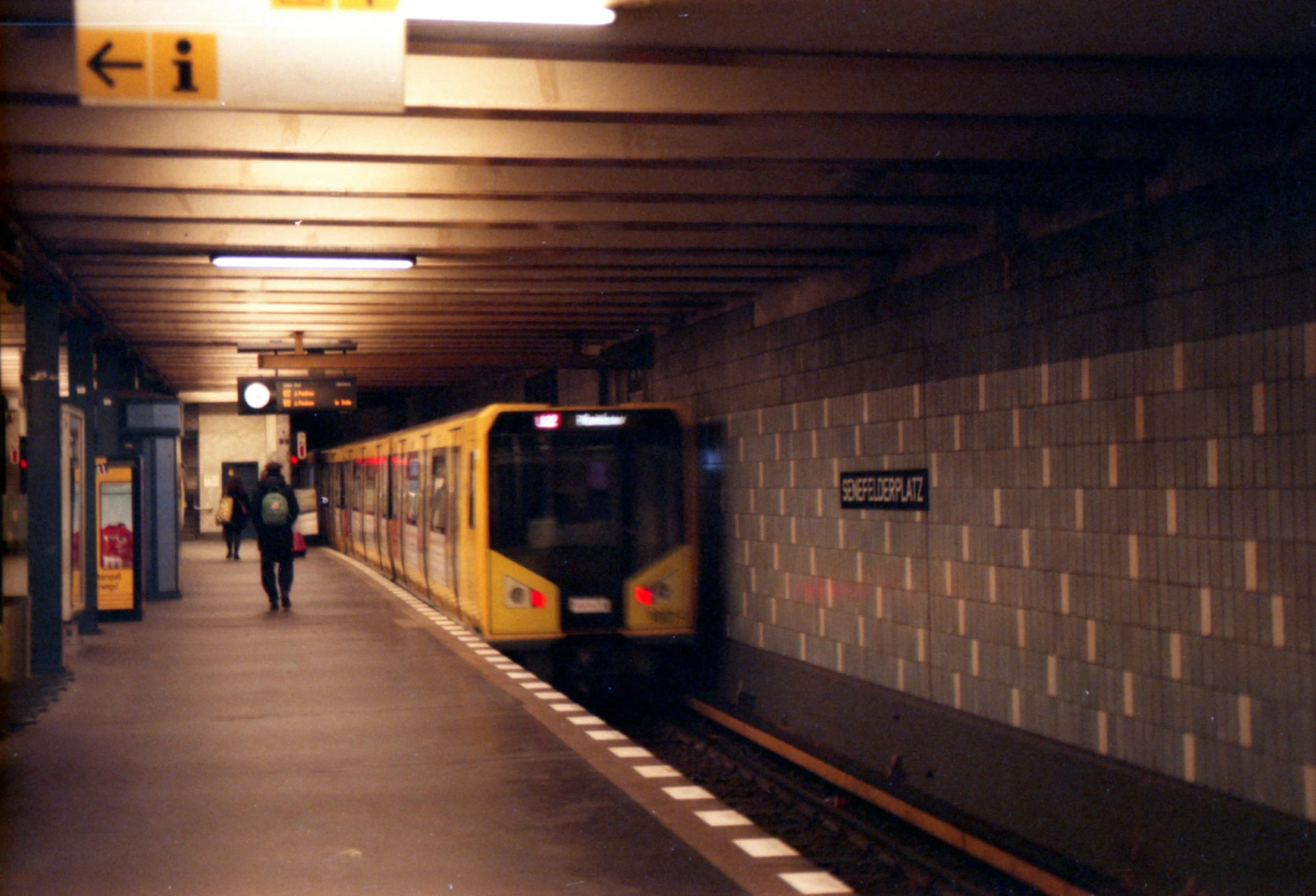 a train is going down the tracks near a platform