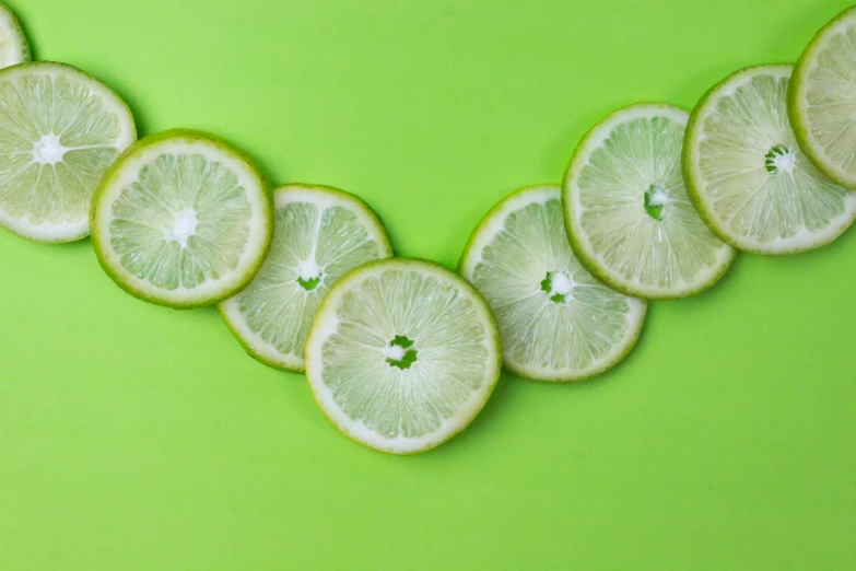 a necklace made of lemon slices on a green background, trending on pexels, 6 pack, green walls, background image