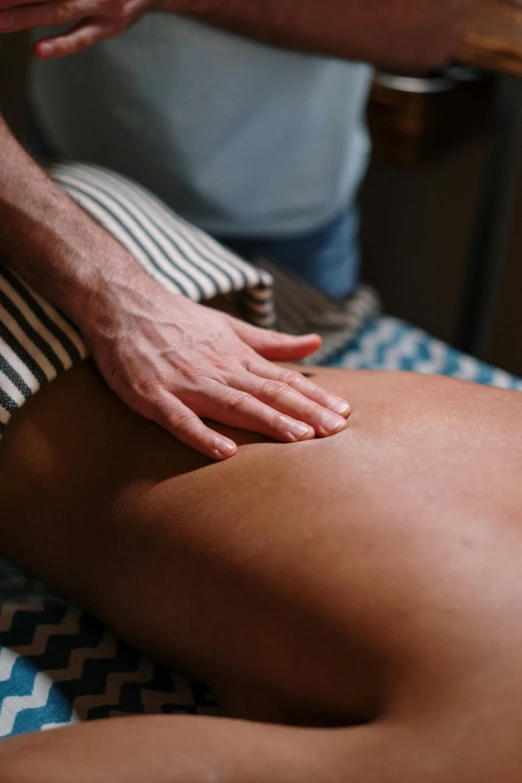 a man getting a back massage at a spa, by Tom Bonson, unsplash, patterned, still photograph, blue, tan