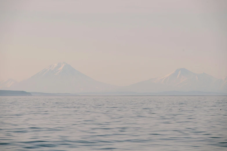 a distant view of a mountain range across the water