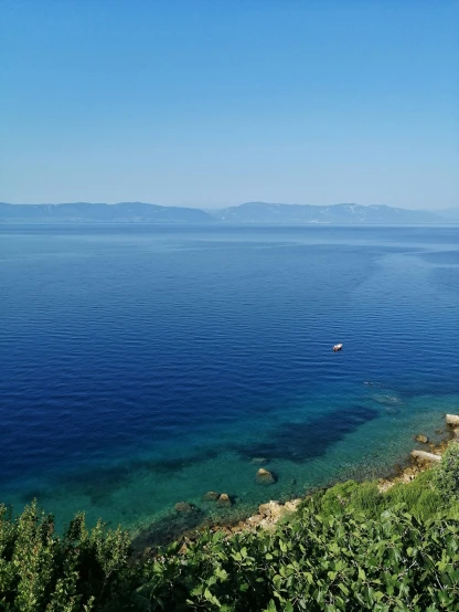 a large body of water sitting on top of a lush green hillside, inspired by Nassos Daphnis, crystal clear blue water, profile image