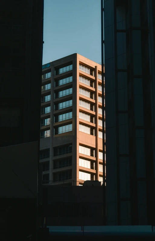 a building seen between some tall buildings