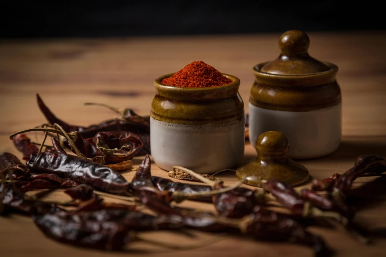 a couple of jars sitting on top of a wooden table, spicy, detailed product image, fan favorite, alphonso azpiri