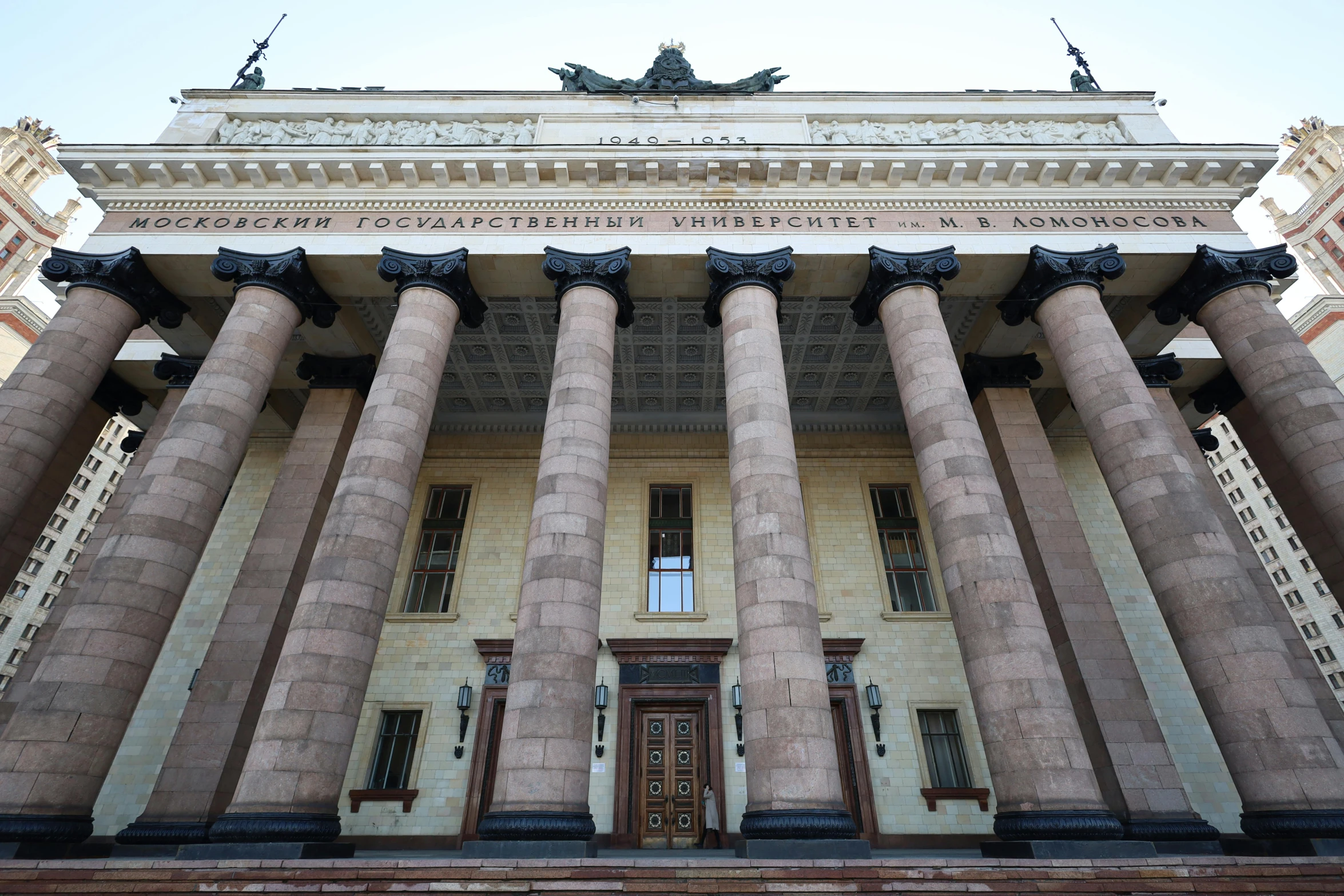 a large building with columns and a clock on top of it, inspired by György Rózsahegyi, unsplash, socialist realism, 000 — википедия, war theatre, gigantic pristine marble columns, facing front