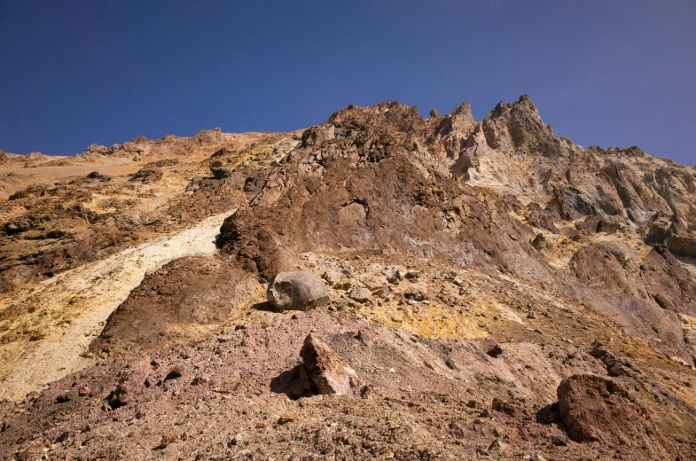 a mountain covered in lots of dirt and grass