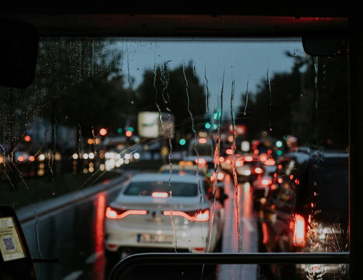 the back window of a bus is looking down at traffic