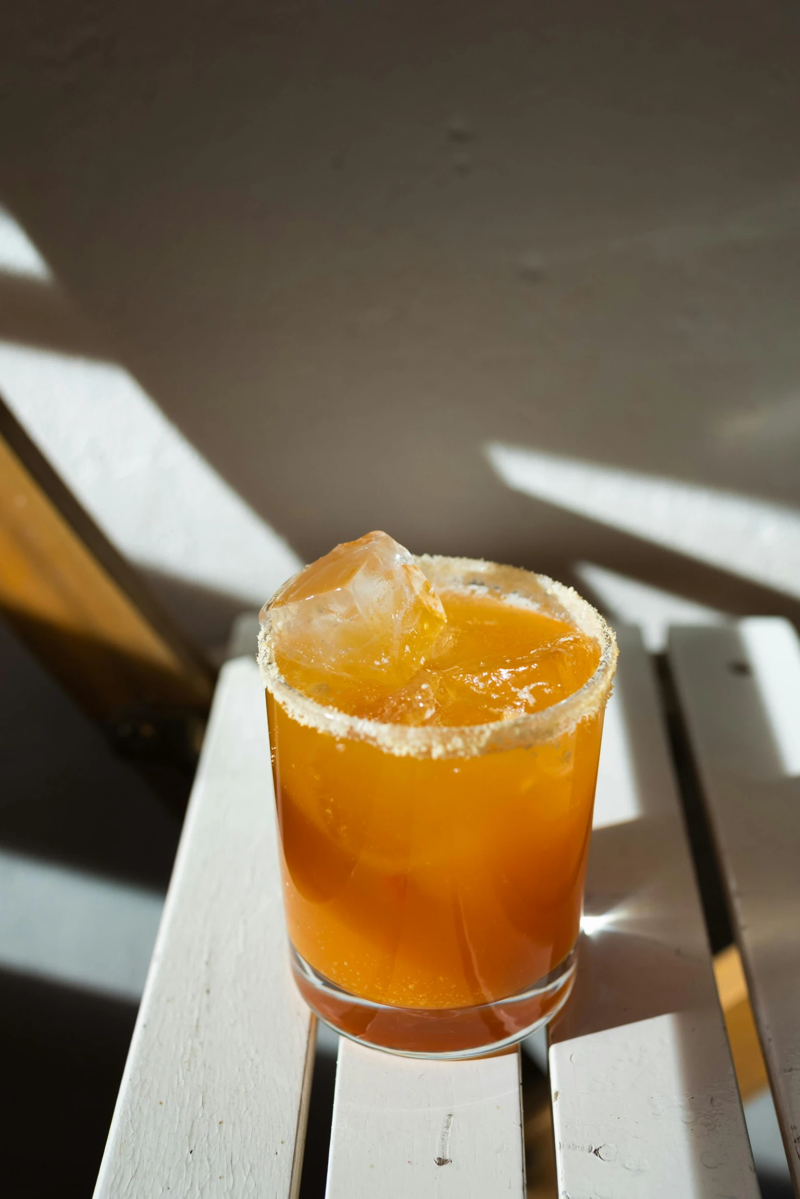 a orange and lemon drink sitting on top of a wooden table