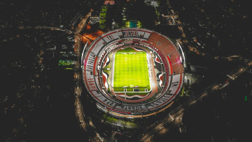 an aerial view of a soccer stadium at night, pexels contest winner, giant aztec spaceship, 💋 💄 👠 👗, neoprene, tourist destination