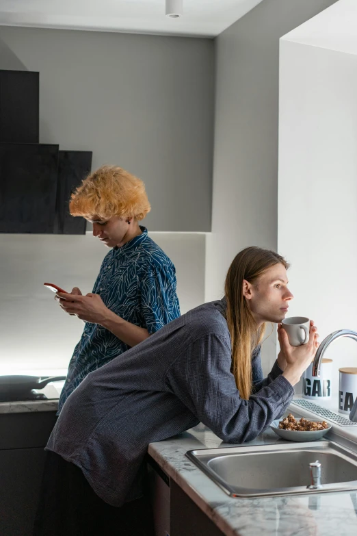 a couple of women standing in a kitchen next to a sink, by Jan Tengnagel, trending on reddit, looking at his phone, non-binary, breakfast, gray men