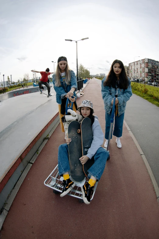 a group of people riding on top of a skateboard ramp, by Attila Meszlenyi, cute girls, e-girl, denim, moped