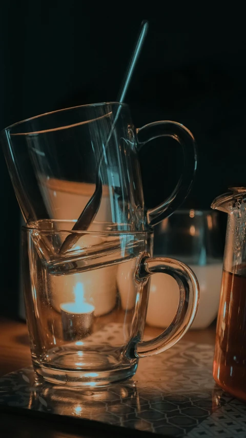 a couple of cups sitting on top of a table, a still life, pexels, captured in low light, inside a beer glass, low quality photo, thumbnail