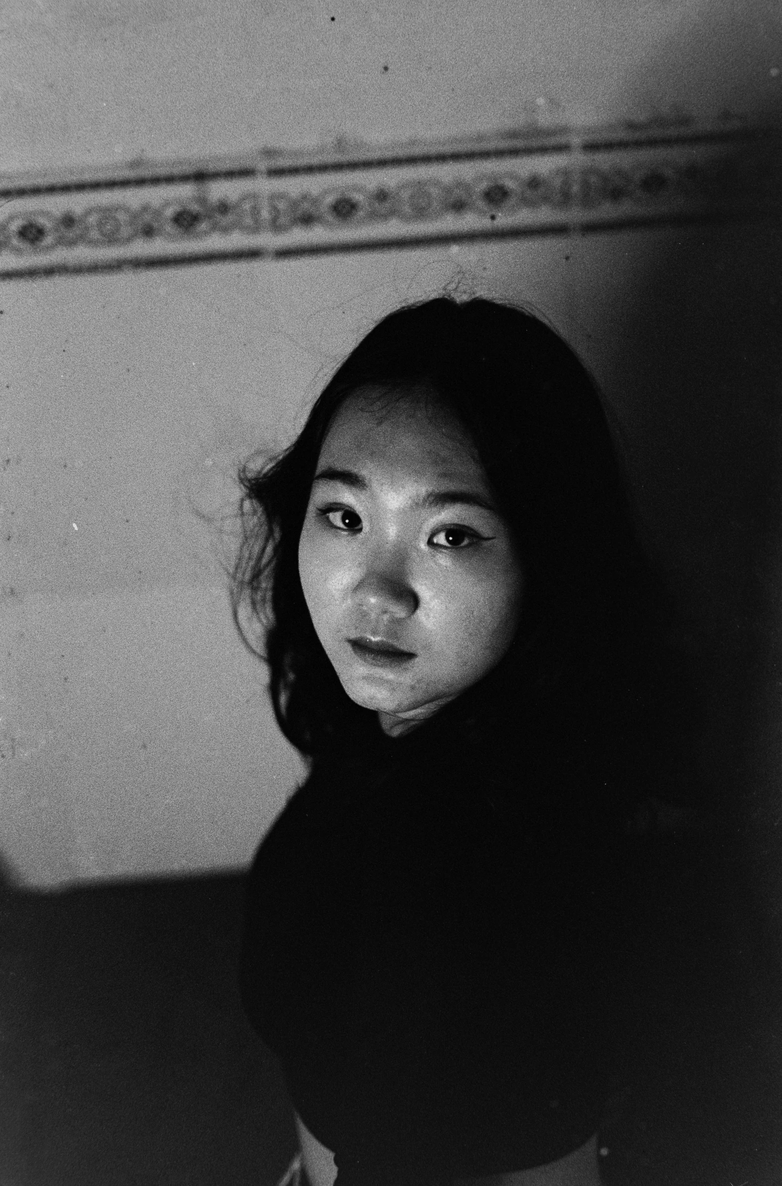 a black and white photo of a woman, inspired by Wang Ximeng, medium format film photography, looking down on the camera, 1 6 years old, ((portrait))