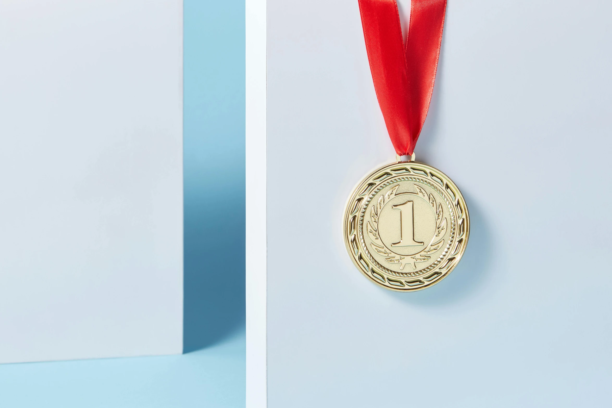 a gold medal with a red ribbon around it, a picture, by Julia Pishtar, pexels contest winner, private press, textured base ; product photos, made out of shiny white metal, golden number, set against a white background