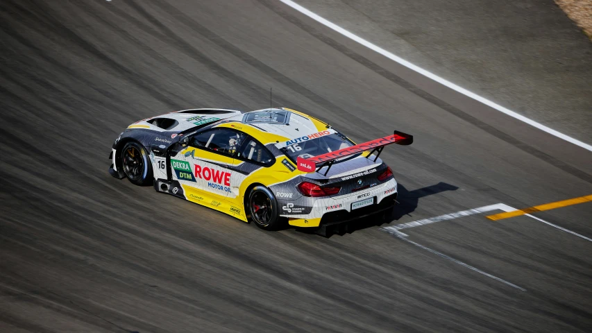 two people drive a racing car along a track