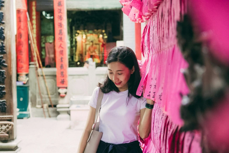 a woman standing in front of a pink wall, inspired by Cui Bai, pexels contest winner, happening, in front of a temple, chinatown, avatar image, profile image