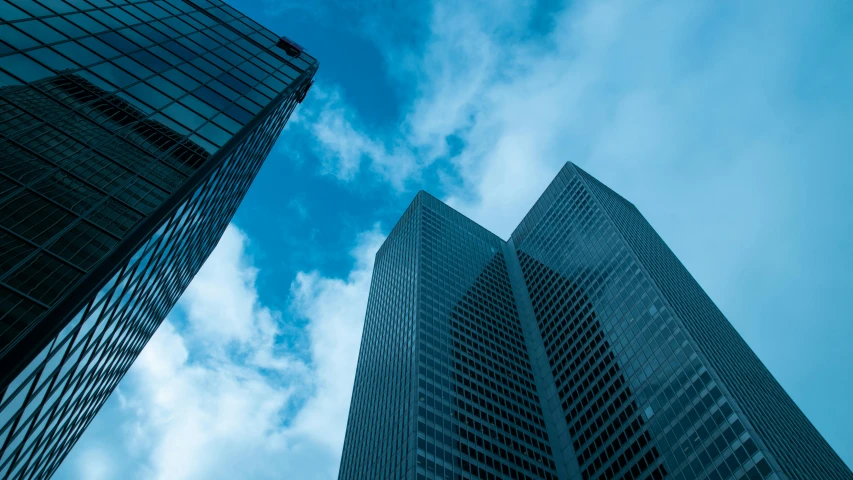 two high rise buildings against the blue sky