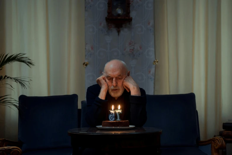 a man sitting in front of a cake with lit candles, a portrait, by Elsa Bleda, pexels contest winner, hyperrealism, portrait of hide the pain harold, berthold woltze, mike ehrmantraut, ignant