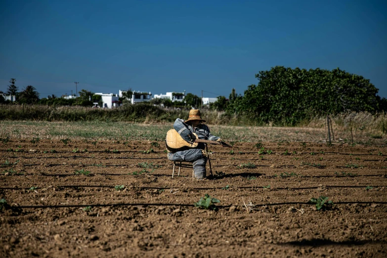 a person with a yellow jacket is working in a field