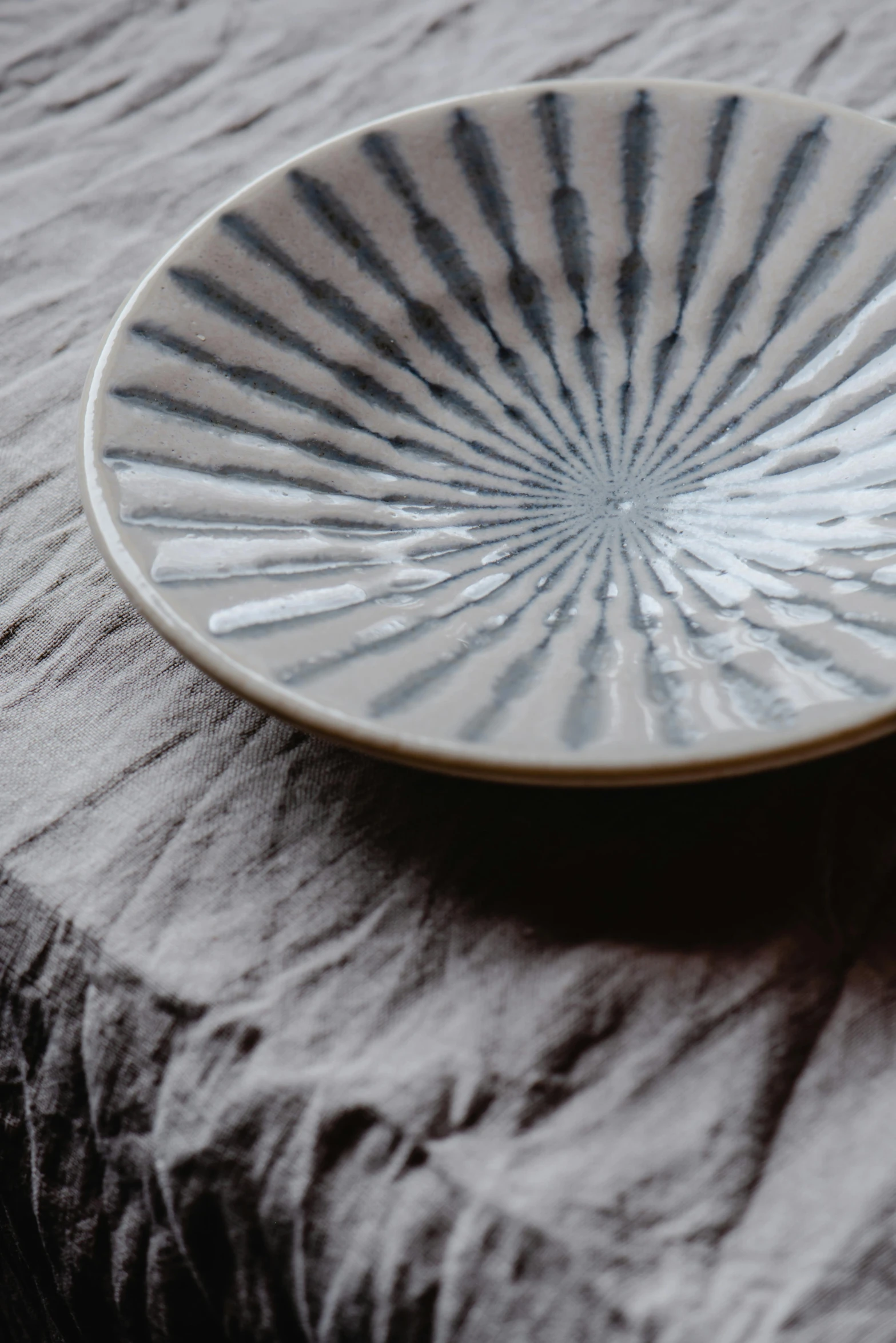 white dish with a spiral design on a plate