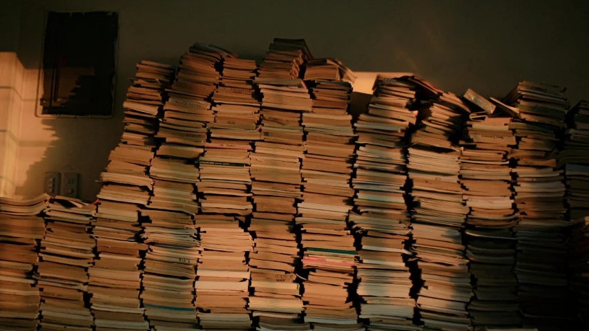 a pile of papers sitting on top of a table, an album cover, by Morris Kestelman, flickr, conceptual art, the library of babel, dimly lit, autechre, taken in the late 2000s