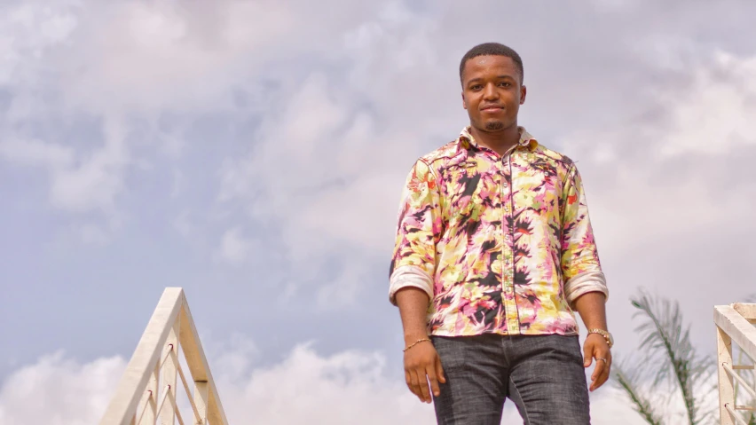 a man standing on a bridge looking at the camera